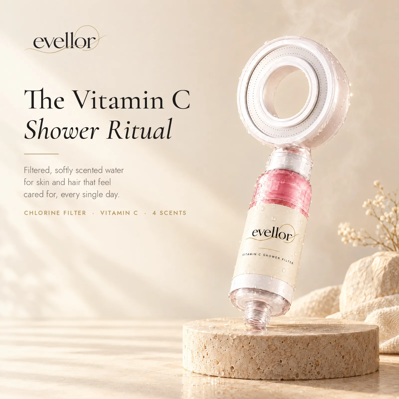 Evellor showerhead with a rose-scented Vitamin C cartridge on warm travertine